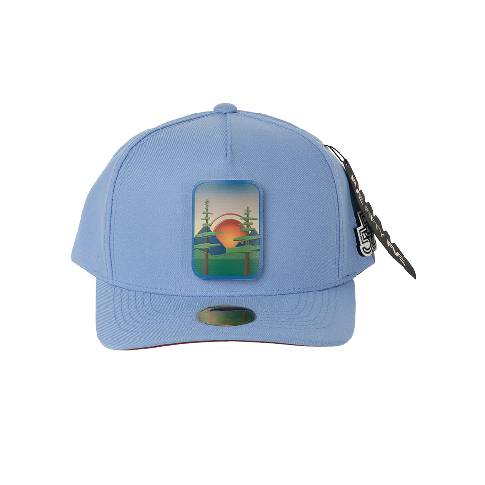 Beyond The Pines blue A-frame snapback hat with forest sunset landscape badge