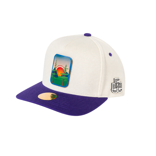 Beyond The Pines cream and purple A-frame snapback hat side view with forest sunset badge and FveFiftyFve logo